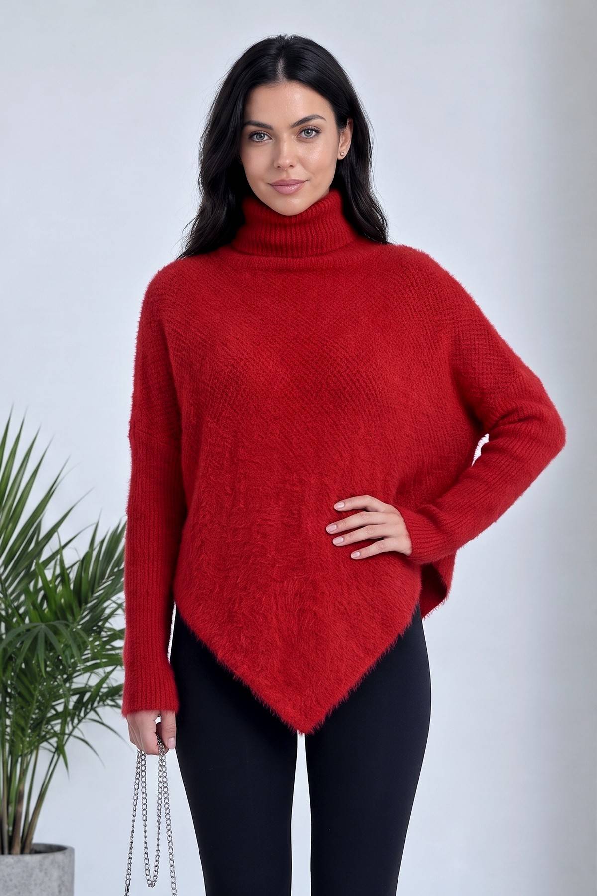 Kırmızı ZKS boğazlı kazak, yumuşak tüylü kumaş, asimetrik kesim, model yandan elini beline koymuş