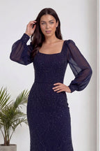 Lacivert kare yaka şifon kollu, balık kesim, işlemeli abiye elbise modelin eli saçında poz verirken