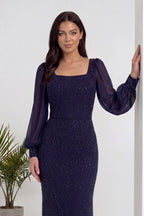 Lacivert kare yaka şifon kollu, balık kesim, işlemeli abiye elbise duvara yaslanmış poz