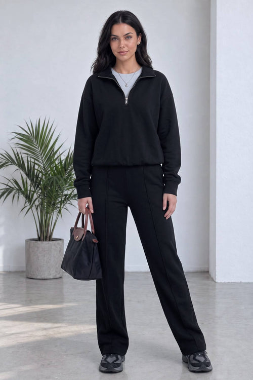 The ZKS siyah yarım fermuarlı sweatshirt ve geniş paça pantolon kombini önden görünüm